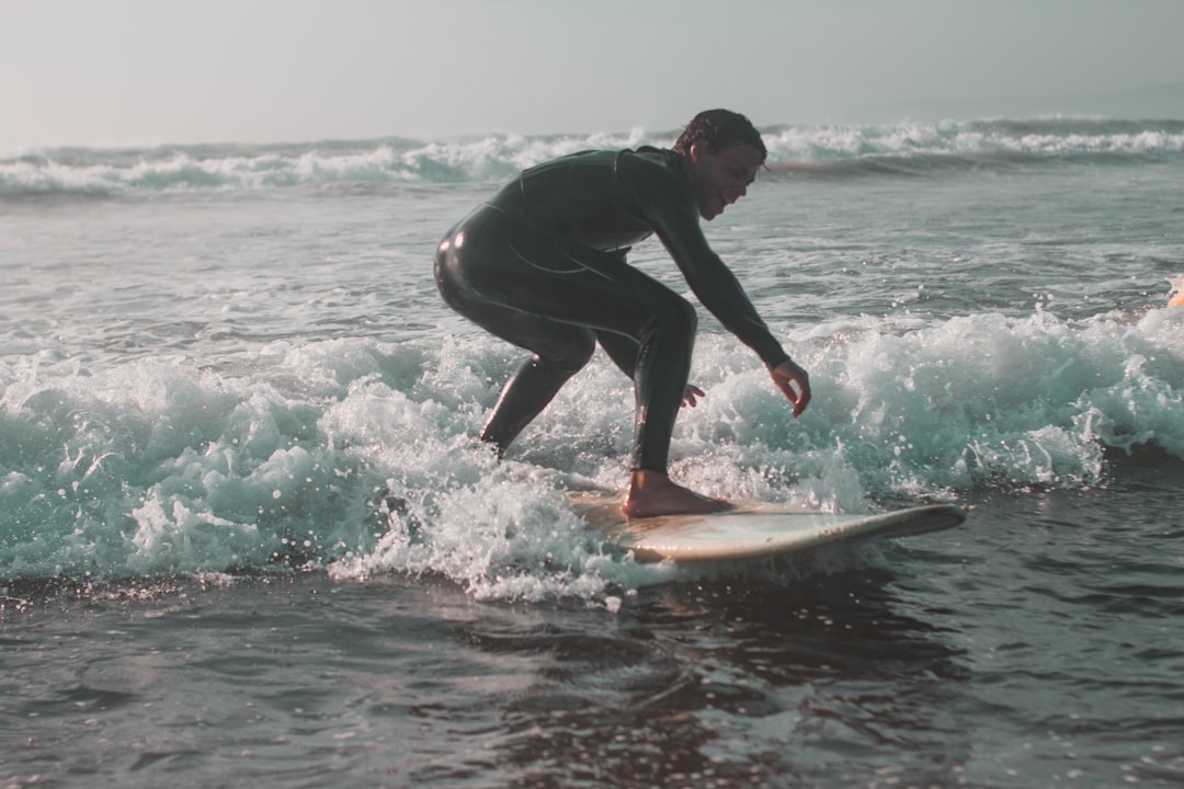 A surfer rides a long mellow wave along the Moroccan Atlantic coast, capturing the spirit of surfing Morocco in summer