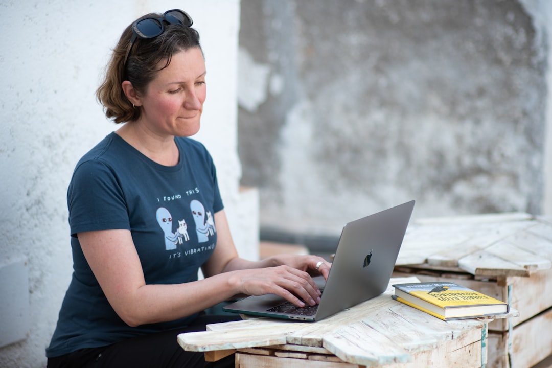 A freelance entrepreneur works at a laptop inside a modern co-working space in Marrakech, Morocco
