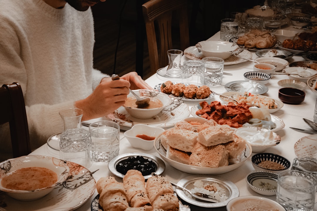 A Moroccan family gathered around a shared tagine during Throne Day celebrations in a traditional home