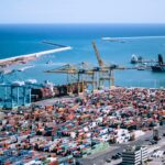 A freight logistics worker inspects containers at Tanger Med port, where post-summer freight demand peaks each autumn
